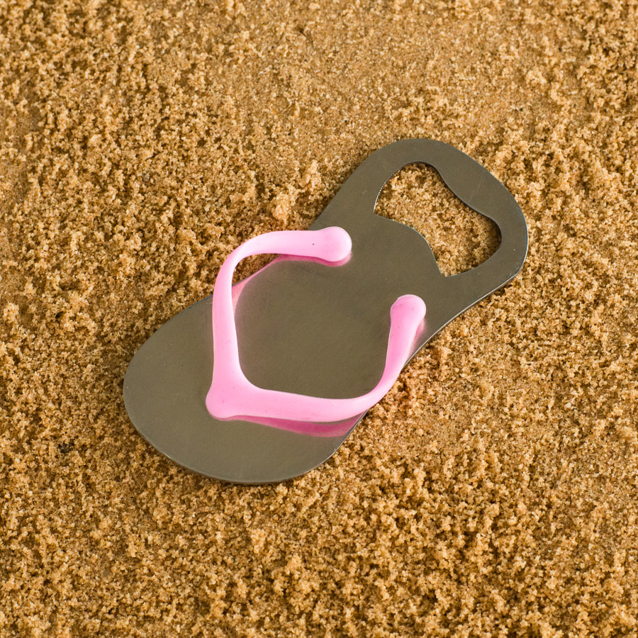Product photographer image of flip flop on sand