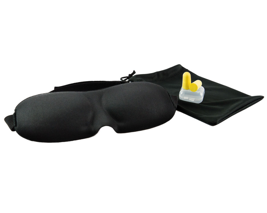 eye mask and ear plugs photographed on a white background
